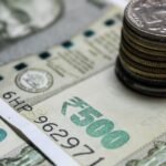 Detailed view of Indian rupees and stacked coins, representing currency and finance.